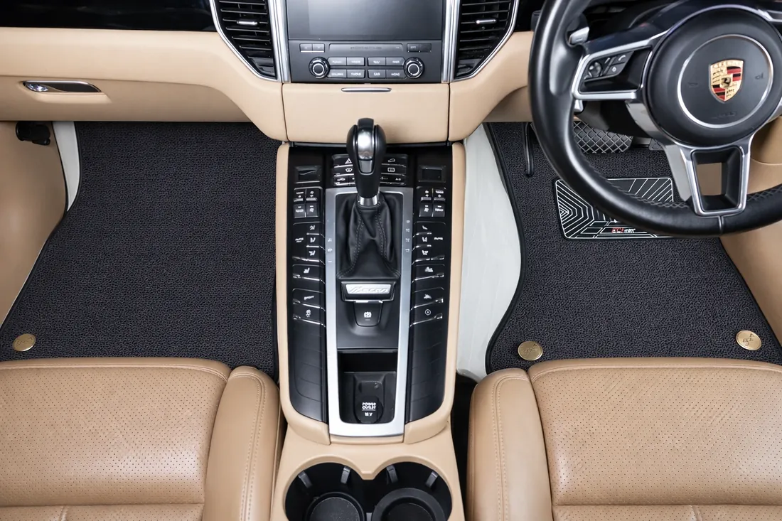 Porsche Macan footwell with the EZYMAT double-layer mat: a black Tex-Mesh top layer over a white Eco-Leather base