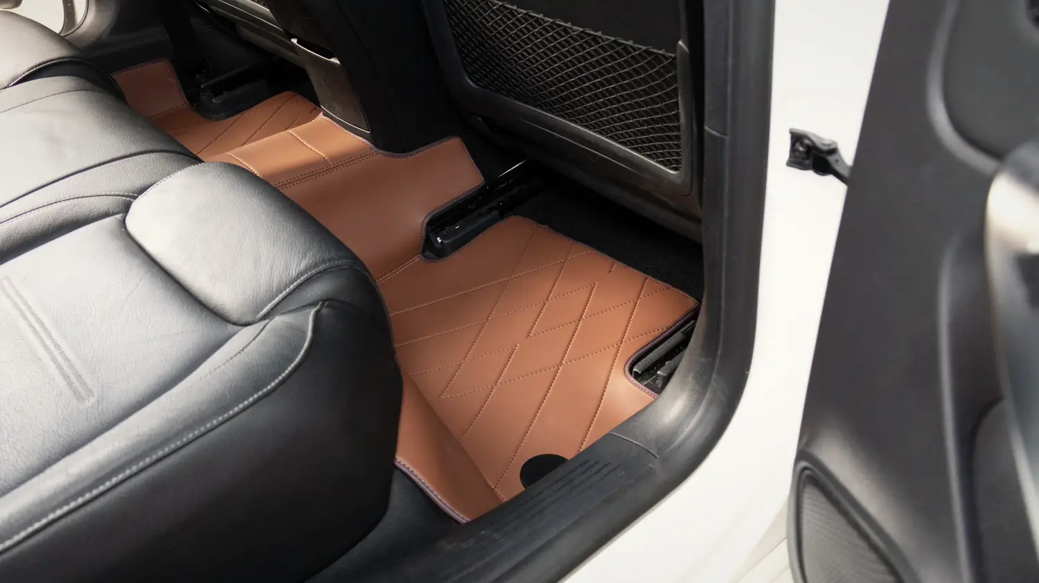 An EZYMAT mat fitted flush in a car, made at the factory in Puncak Alam